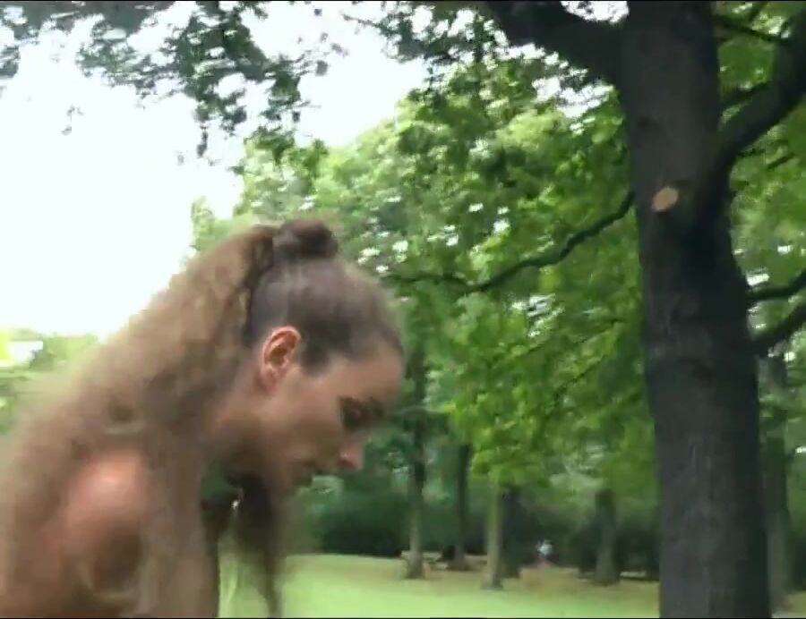 almost naked Nadine selfcuffed and is walking through the public park