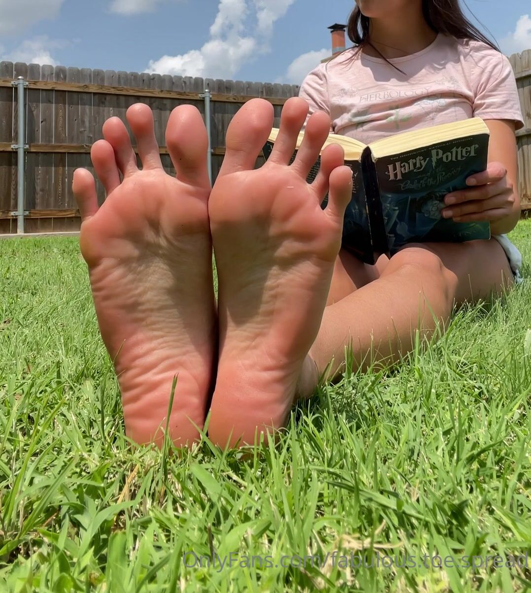 Fabulous Toespread wiggling her toes while reading a book