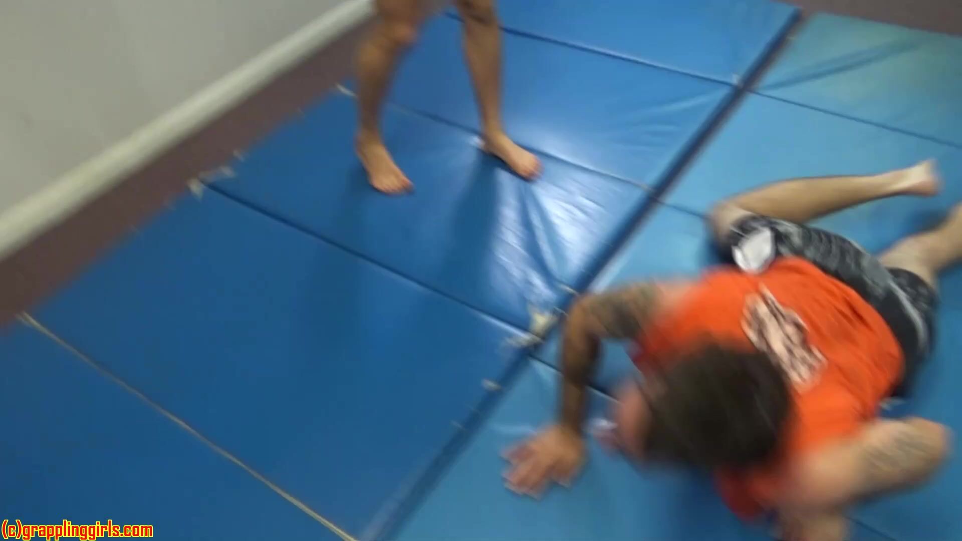 Two girls wrestling man