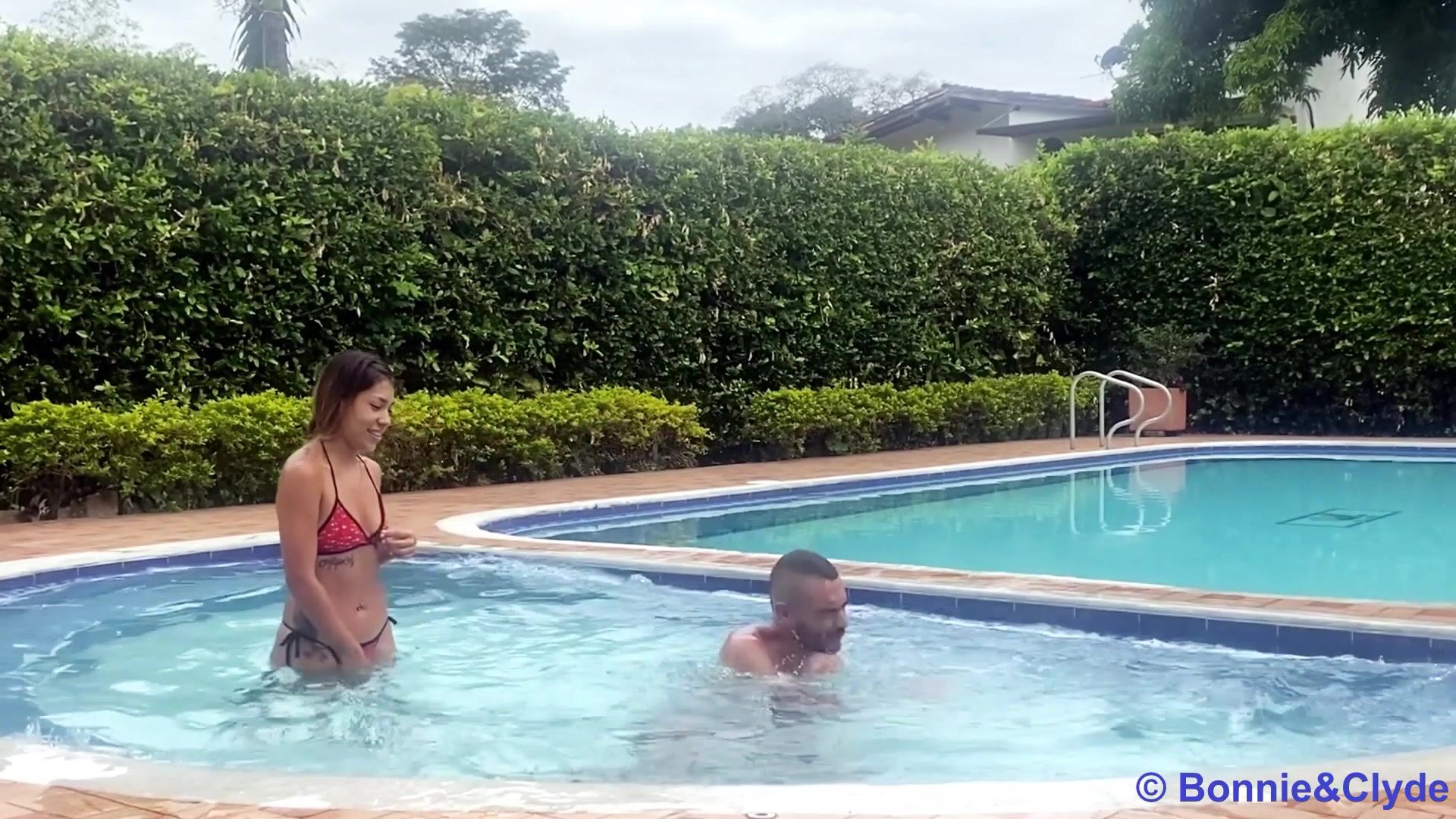 stronger chick casually lifts weakling at pool