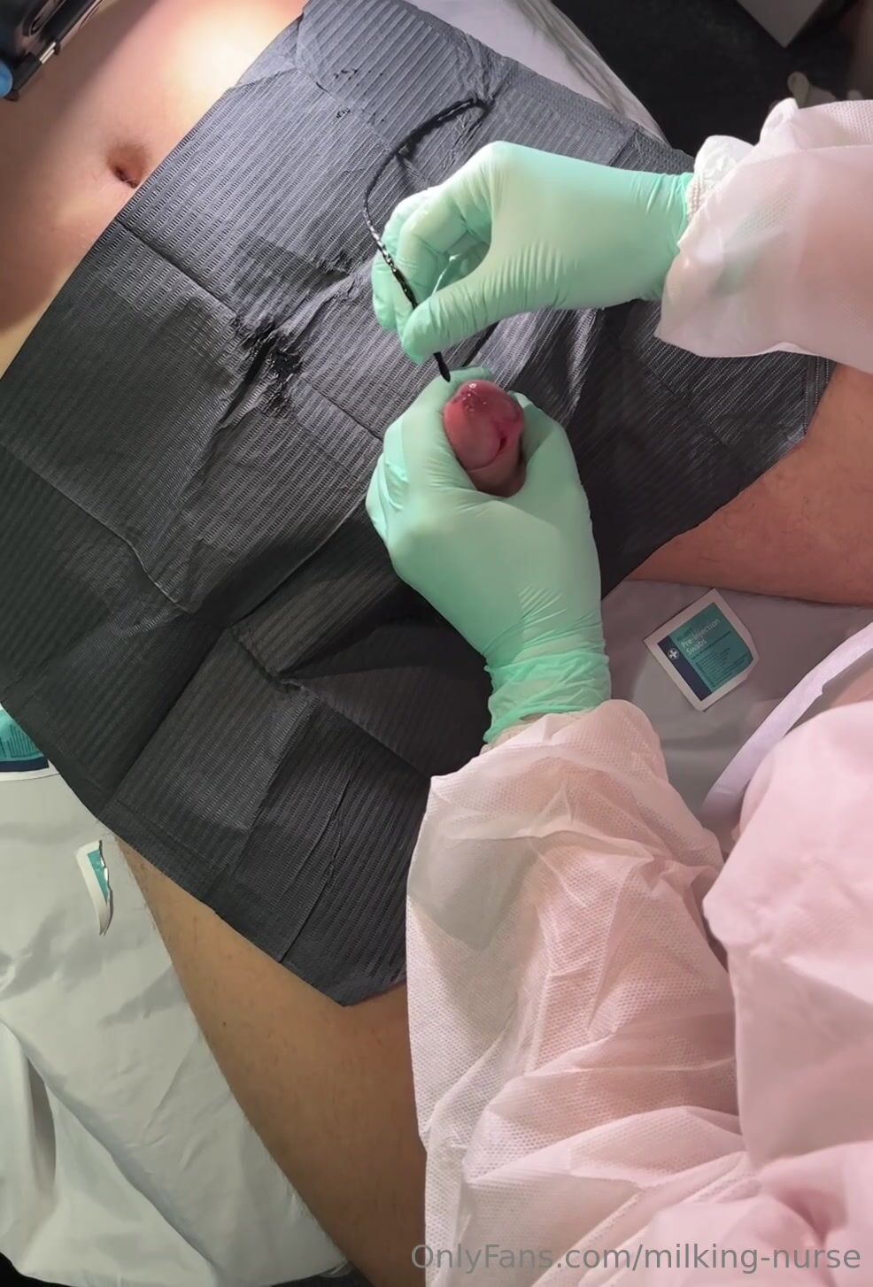Milking nurse milking and sounding in teal gloves