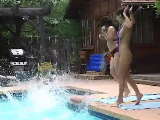 Two tall women lift and carry a little asian